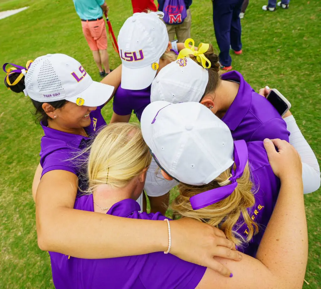 Players forming a huddle/ JWS
