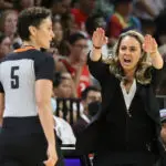 Aces coach Becky Hammon disputes a call with referee Tiara Cruse during the 2022 WNBA semifinals.