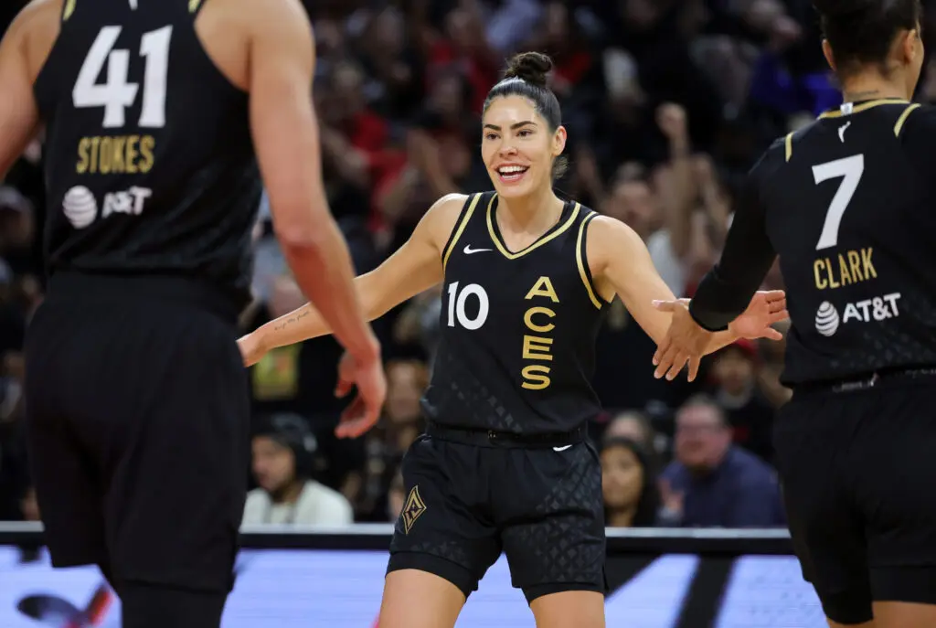 WNBA star Kelsey Plum celebrates on the court.