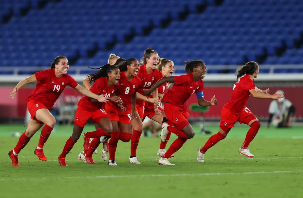 Team Canada celebrate their victory in the 2020 Olympic Gold Medal Match with Sweden