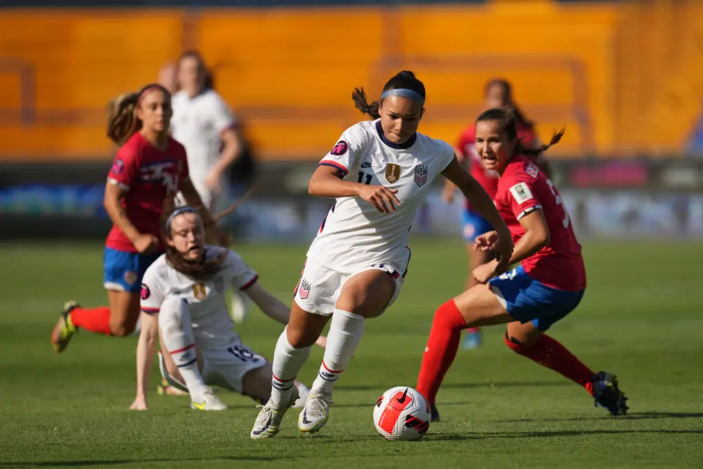 USWNT striker Sophia Smith dribbles through Costa Rican defenders during a 2022 Concacaf W Championship game.