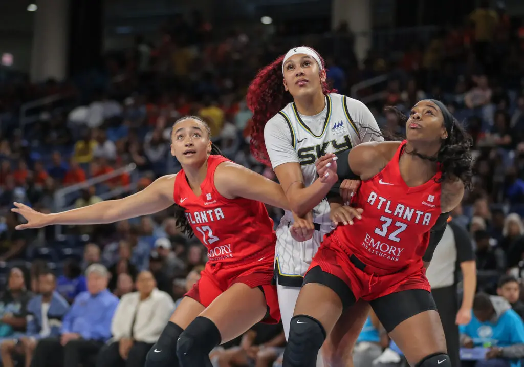 Atlanta's Haley Jones and Cheyenne Parker-Tyus box out Chicago Sky player Kamilla Cardoso in a July WNBA game
