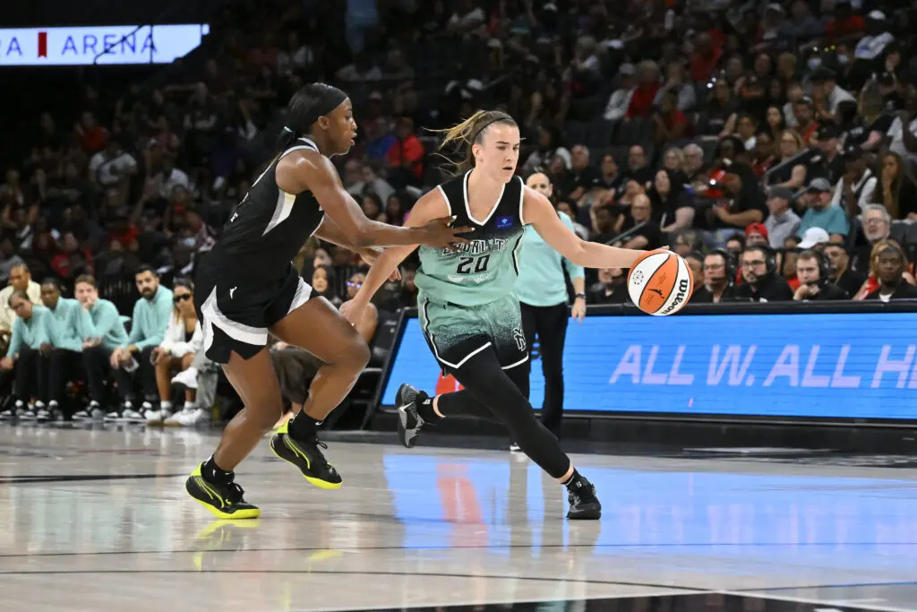 Sabrina Ionescu dribbles past Jackie Young in the Liberty's postseason-clinching win over the Aces on Saturday