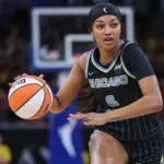WNBA star and McDonald's partner Angel Reese of the Chicago Sky brings the ball up court during the game against the Indiana Fever.