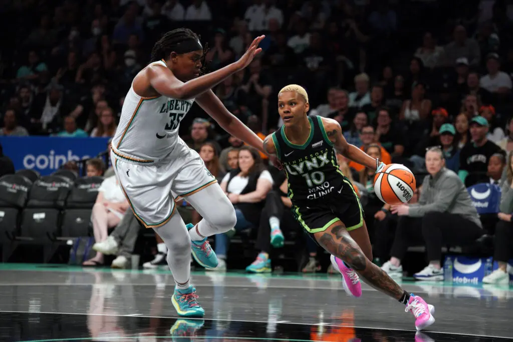 Minnesota's Courtney Williams dribbles around New York's Jonquel Jones.