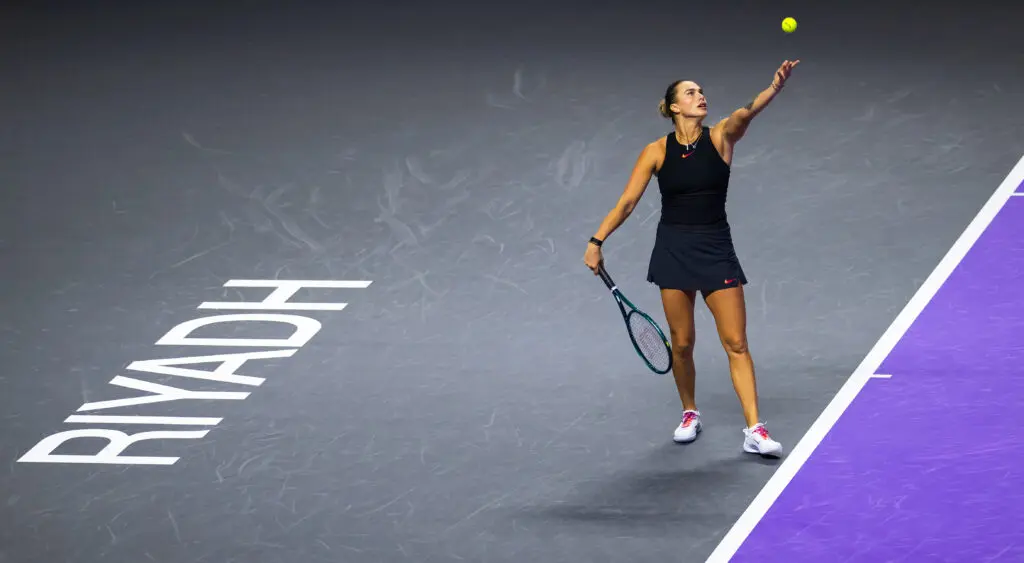 World No. 1 Aryna Sabalenka tosses a serve at the 2024 WTA Finals.