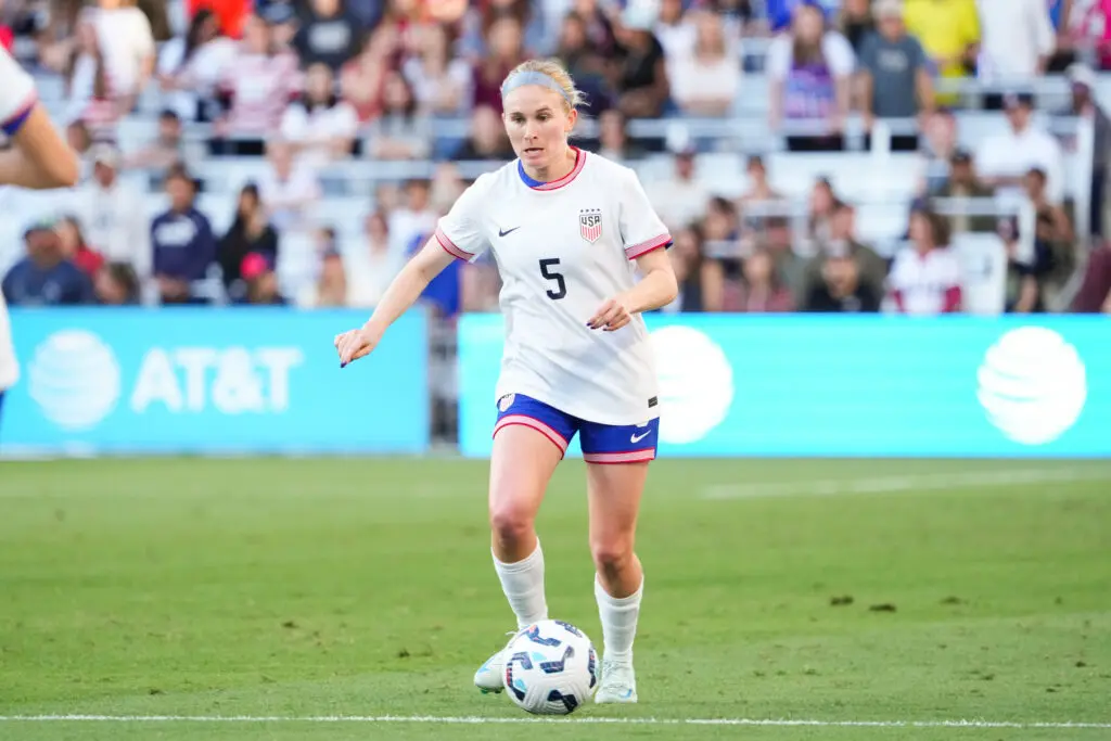 NWSL star and Arsenal signing Jenna Nighswonger dribbles the ball during a USWNT game.