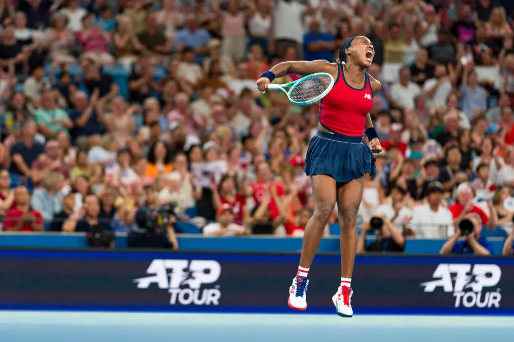 Tennis star Coco Gauff leaps in celebration over a point against Iga Świątek in the United Cup final.