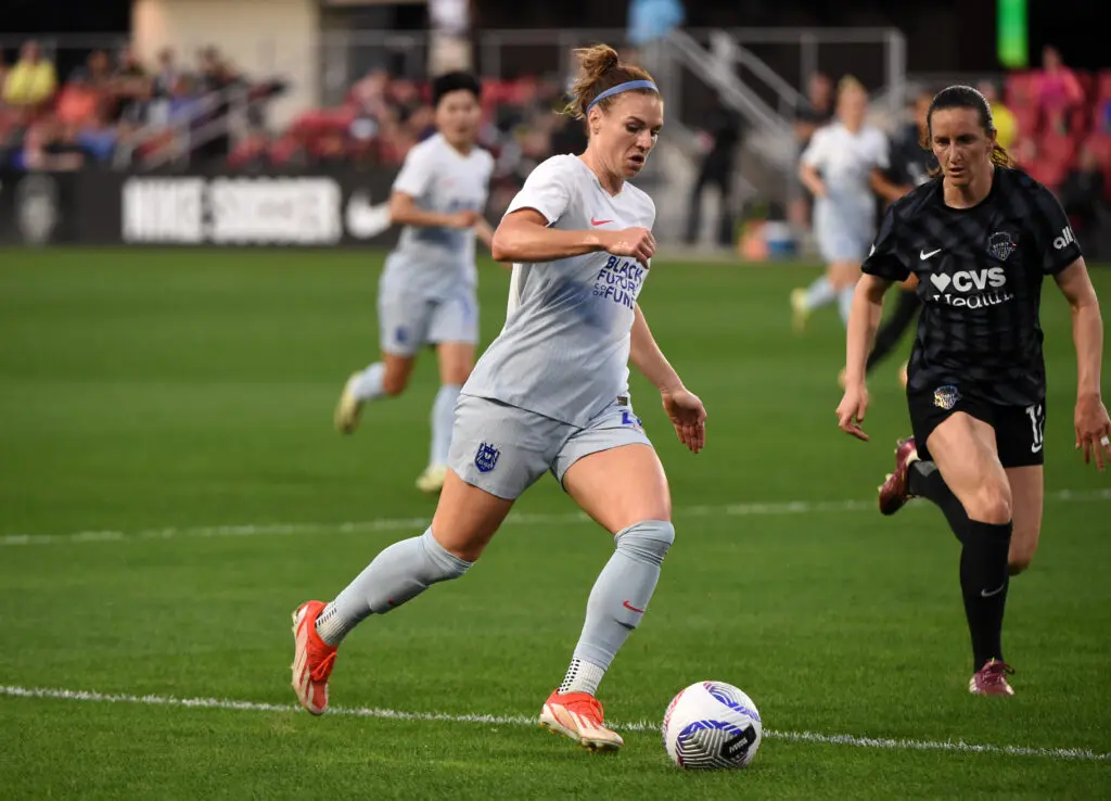 Seattle Reign's Veronica Latsko dribbles the ball during a 2024 NWSL match against the Washington Spirit.