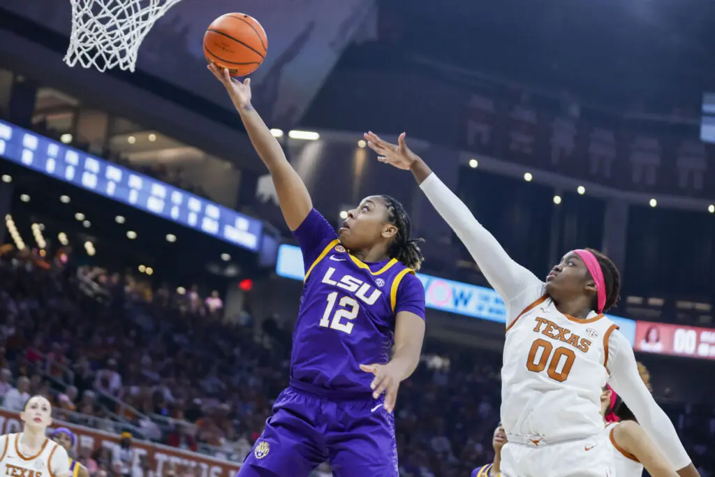 LSU's Mikaylah Williams lays up a shot past Texas's Kyla Oldacre during a 2025 SEC basketball game.