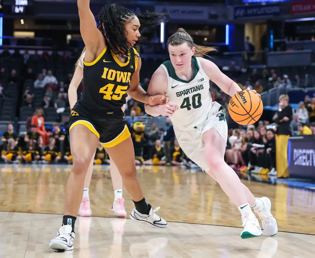 Iowa's Hannah Stuelke defends Michigan State's Julia Ayrault during a 2025 Big Ten basketball tournament game.