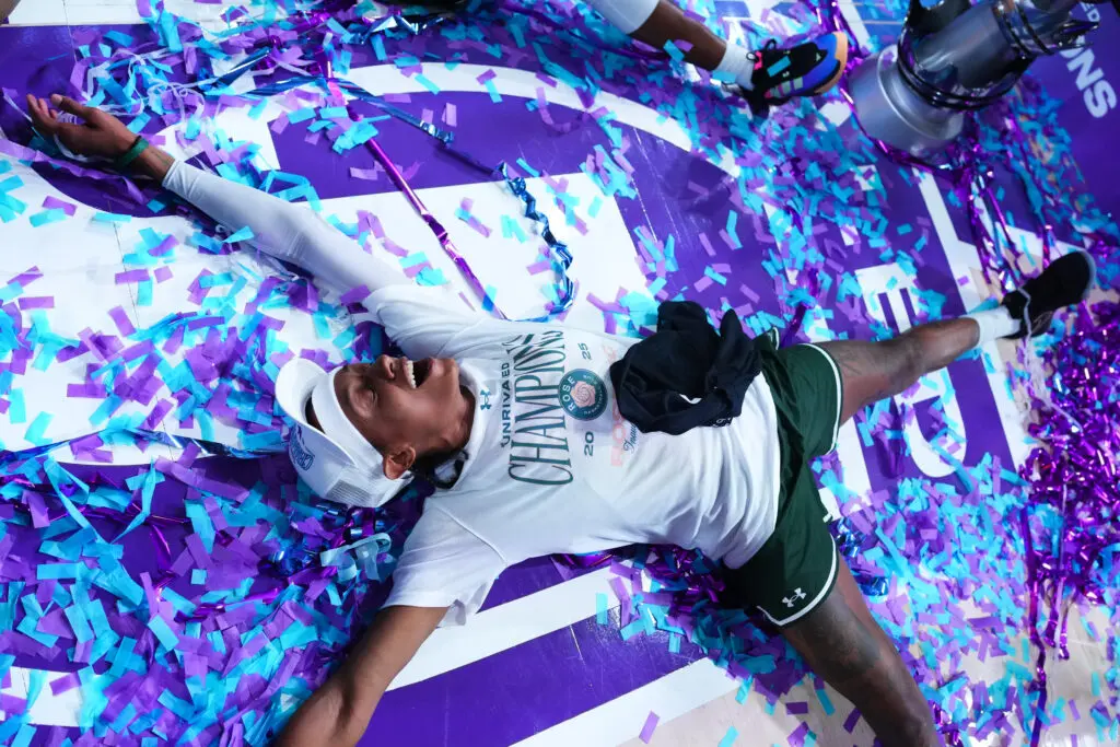 Rose BC's Brittney Sykes makes snow angels in the championship confetti on the Unrivaled court.