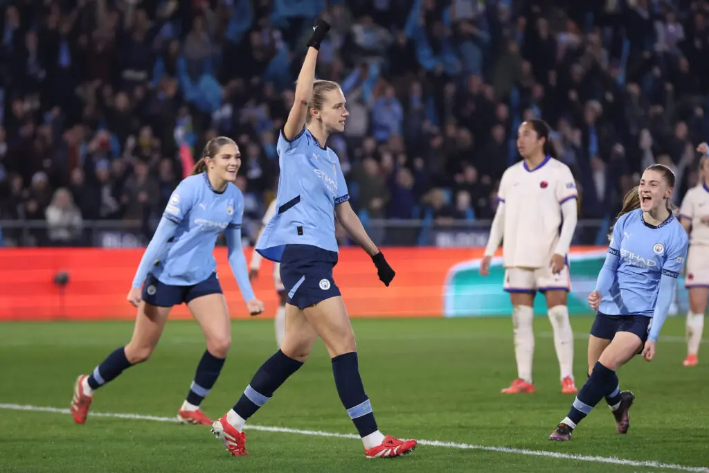 Vivianne Miedema lifts her arm in triumph after scoring the game-winning goal in Man City's first Champions League quarterfinal.