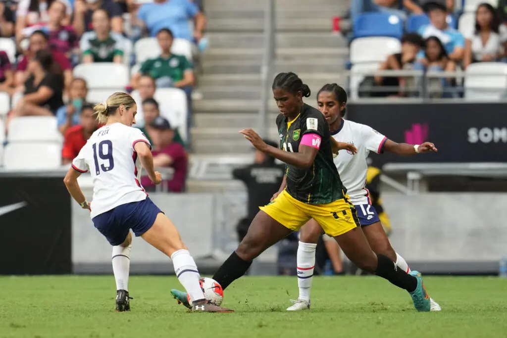 Jamaica's Khadija 'Bunny' Shaw battles USWNT defenders Emily Fox and Naomi Girma for the ball during a 2022 Concacaf Championship match.