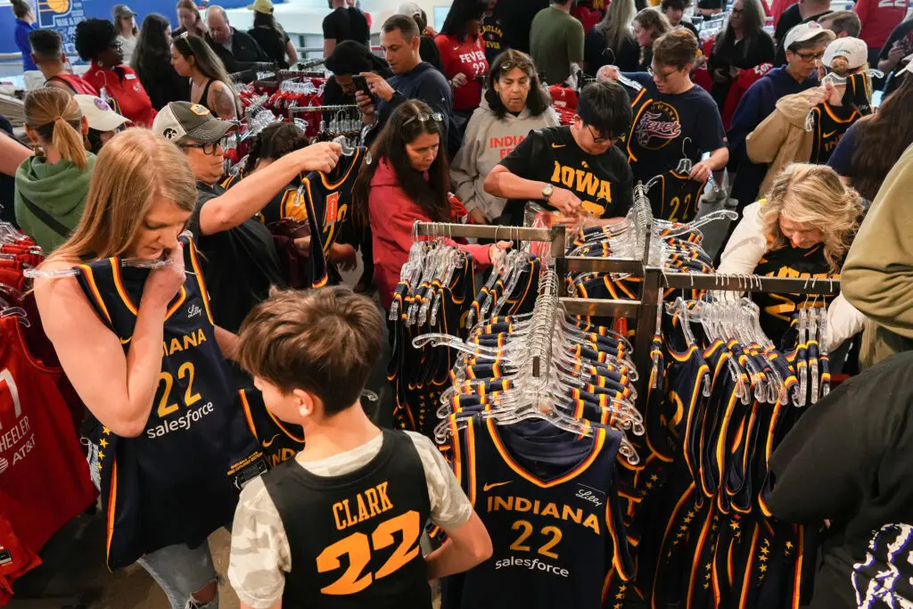 Fans clamor to buy Indiana Fever star Caitlin Clark jerseys before a 2024 WNBA game.