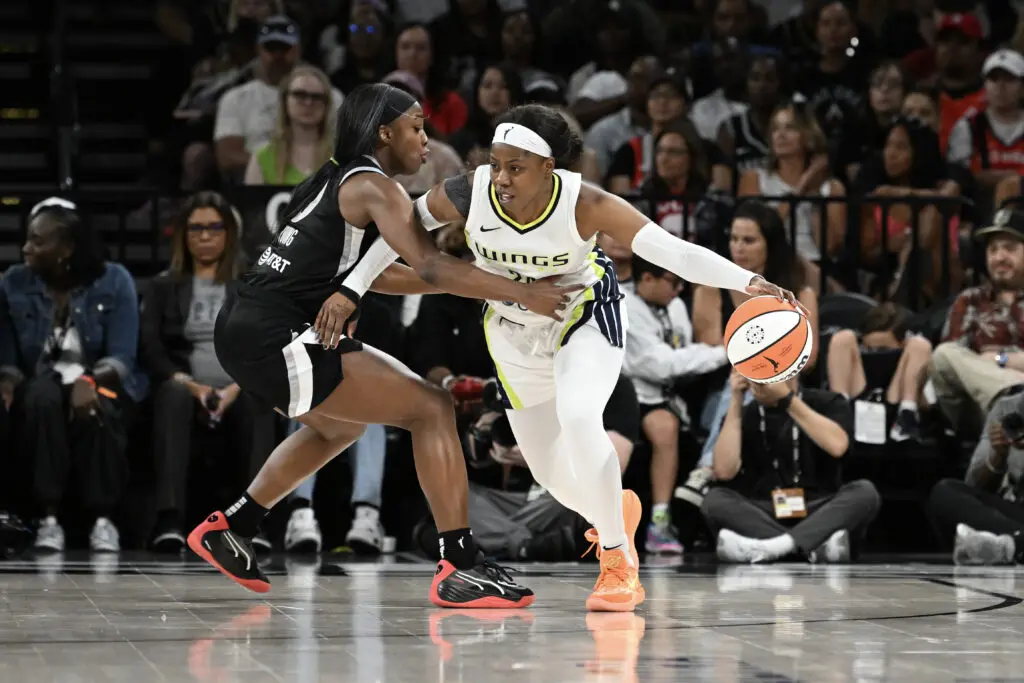 Las Vegas's Jackie Young defends Dallas's Arike Ogunbowale during a 2024 WNBA game.