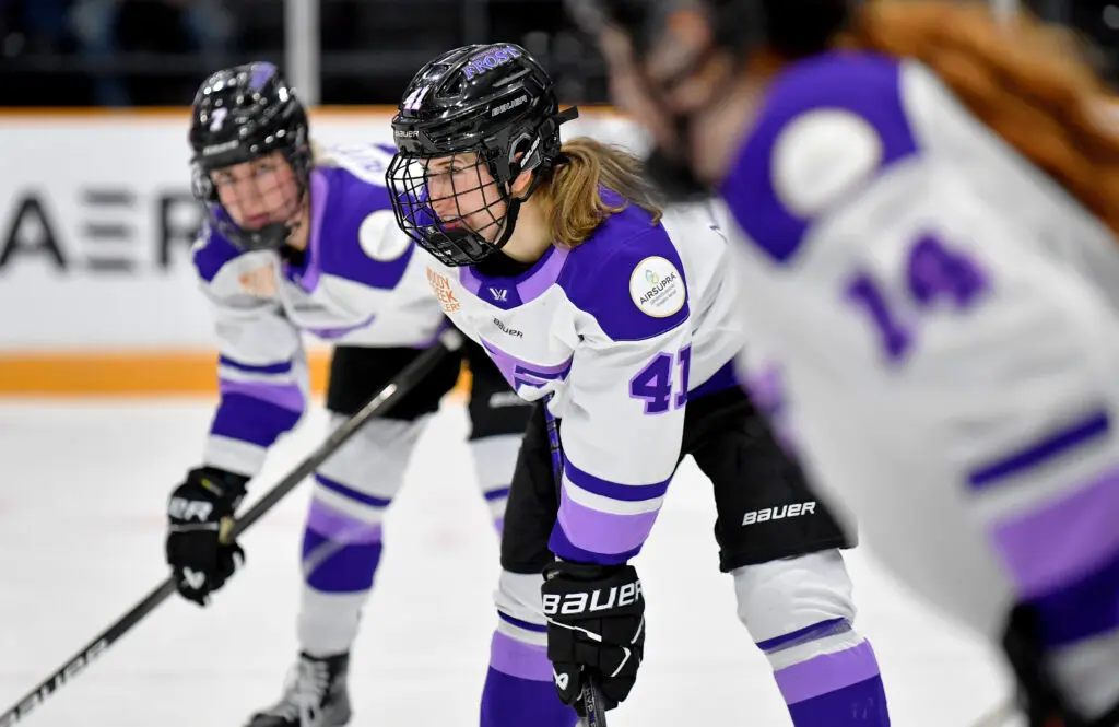 Minnesota's Denise Krizova and Frost teammates line up for a faceoff during a 2025 PWHL game.
