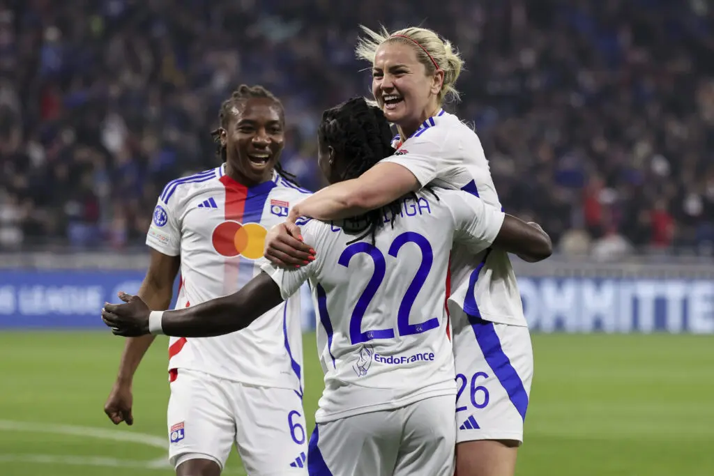 Lyon's Lindsey Heaps and Melchie Dumornay celebrate teammate Tabitha Chawinga's goal during the 2024/25 Champions League quarterfinals.