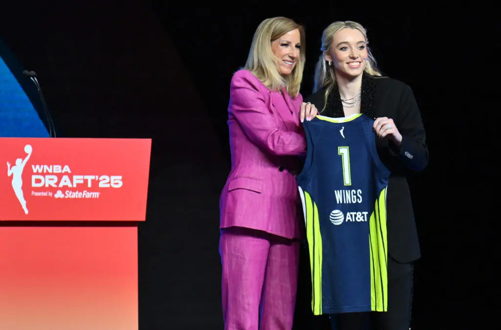 Overall No. 1 pick Paige Bueckers holds a Dallas Wings jersey with commissioner Cathy Engelbert at the 2025 WNBA Draft.