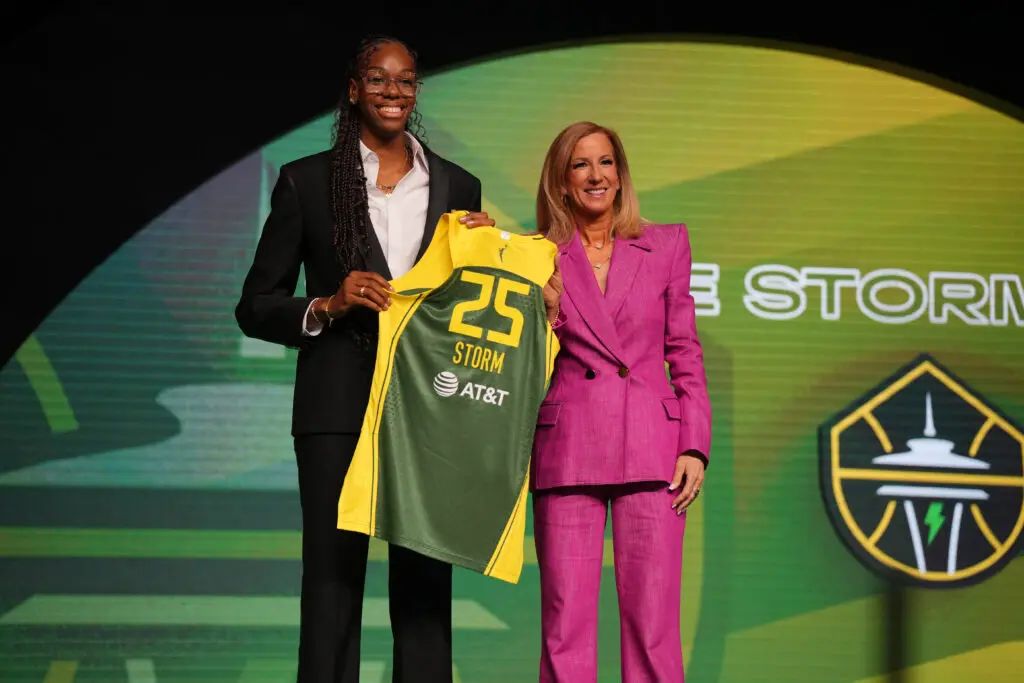 No. 2 pick Dominique Malonga holds a Seattle Storm jersey with commissioner Cathy Engelbert at the 2025 WNBA Draft.