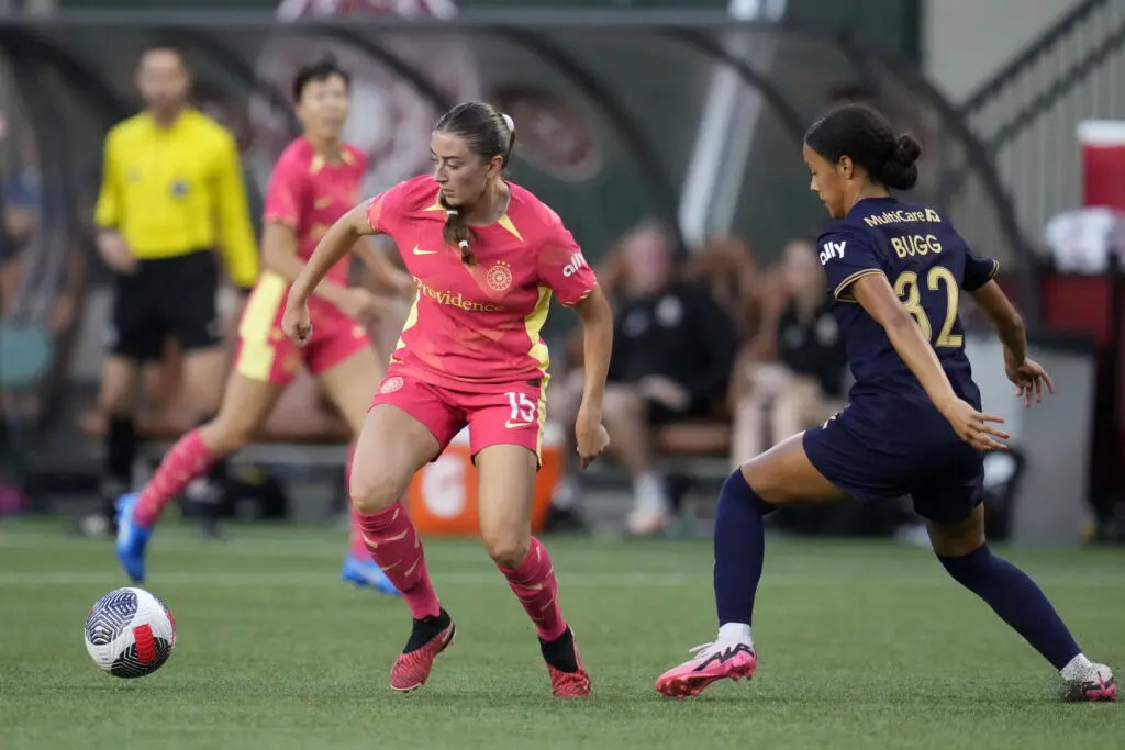 Seattle's Jordyn Bugg defends NWSL rival Portland's Payton Linnehan during a 2024 Cascadia Clash match.