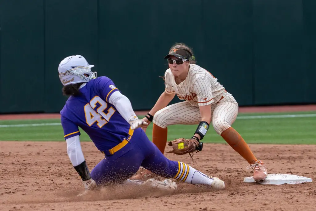 Texas softball's Leighann Goode tries to tag out LSU's Tori Edwards during a 2025 SEC game.