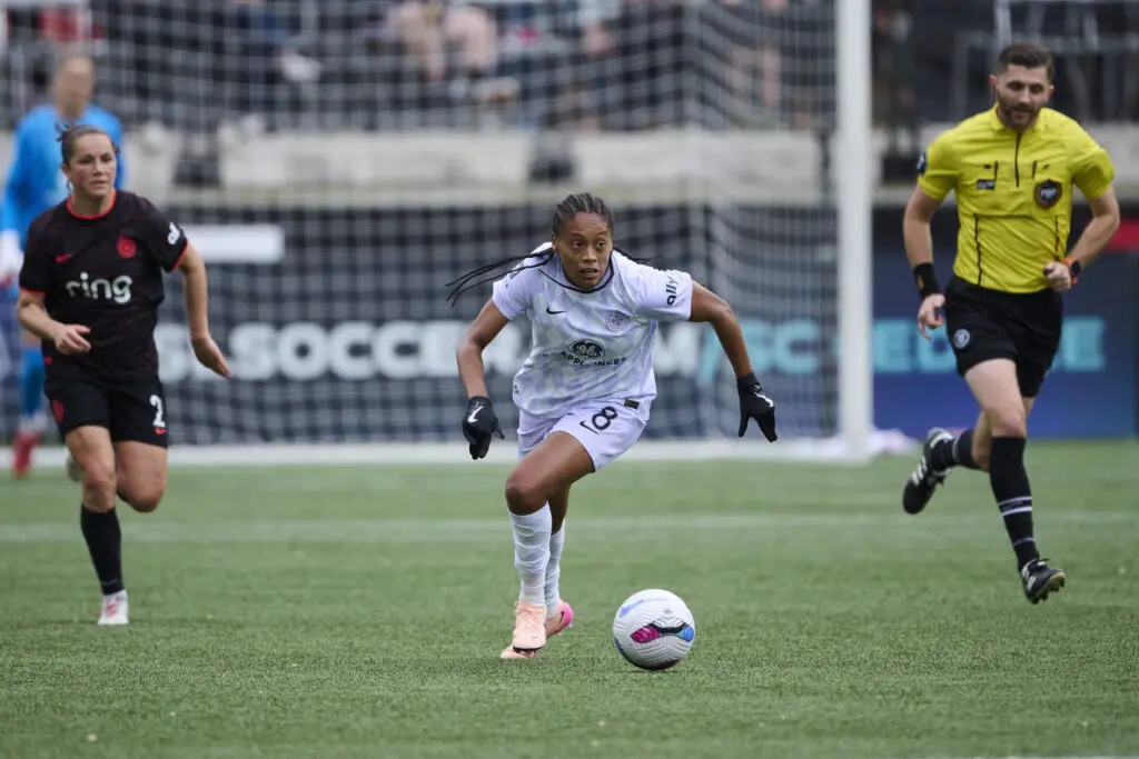 Portland's Jessie Fleming chases Louisville's Ary Borges during Sunday's NWSL game.