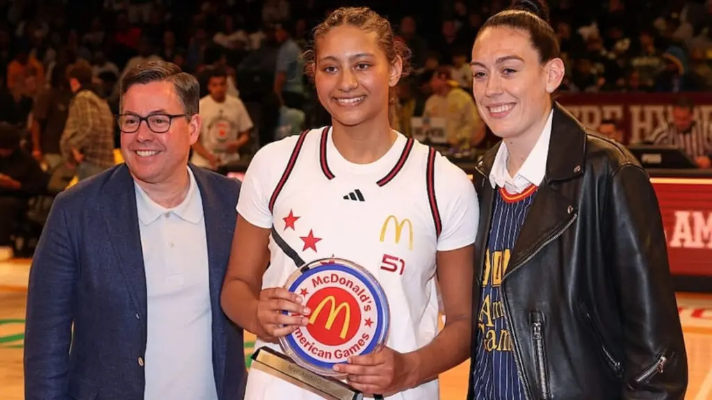 : McDonalds Girls West High School Allstar player Sienna Betts (51) is presented the MVP award by Breanna Stewart during the McDonalds High School All American Girls Game.
