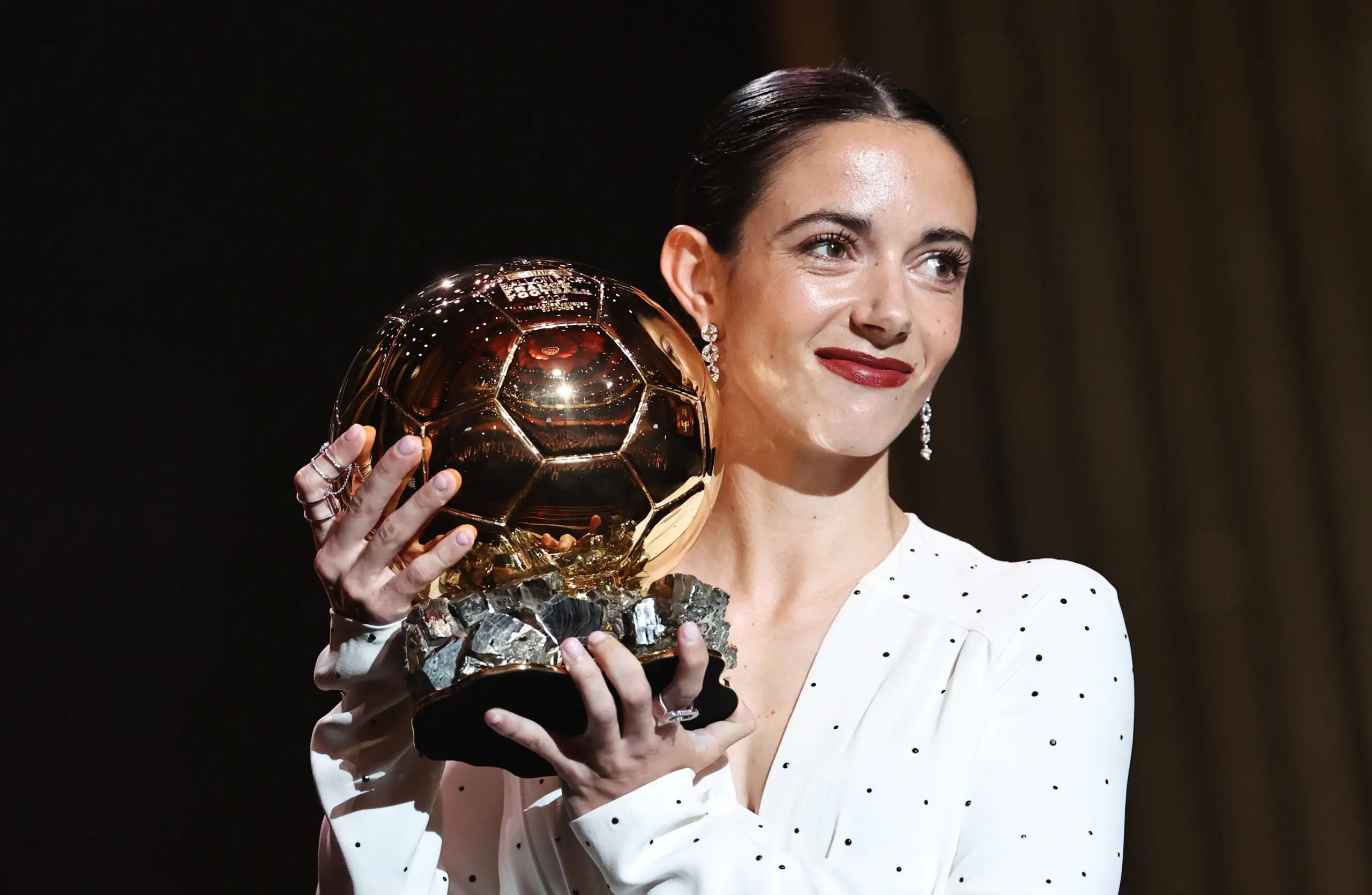Spain’s Aitana Bonmatí poses holding her 2024 Ballon d'Or trophy.