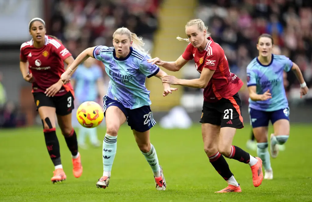 Arsenal's Alessia Russo and Manchester United's Millie Turner battle for the ball during a 2024/25 WSL match.