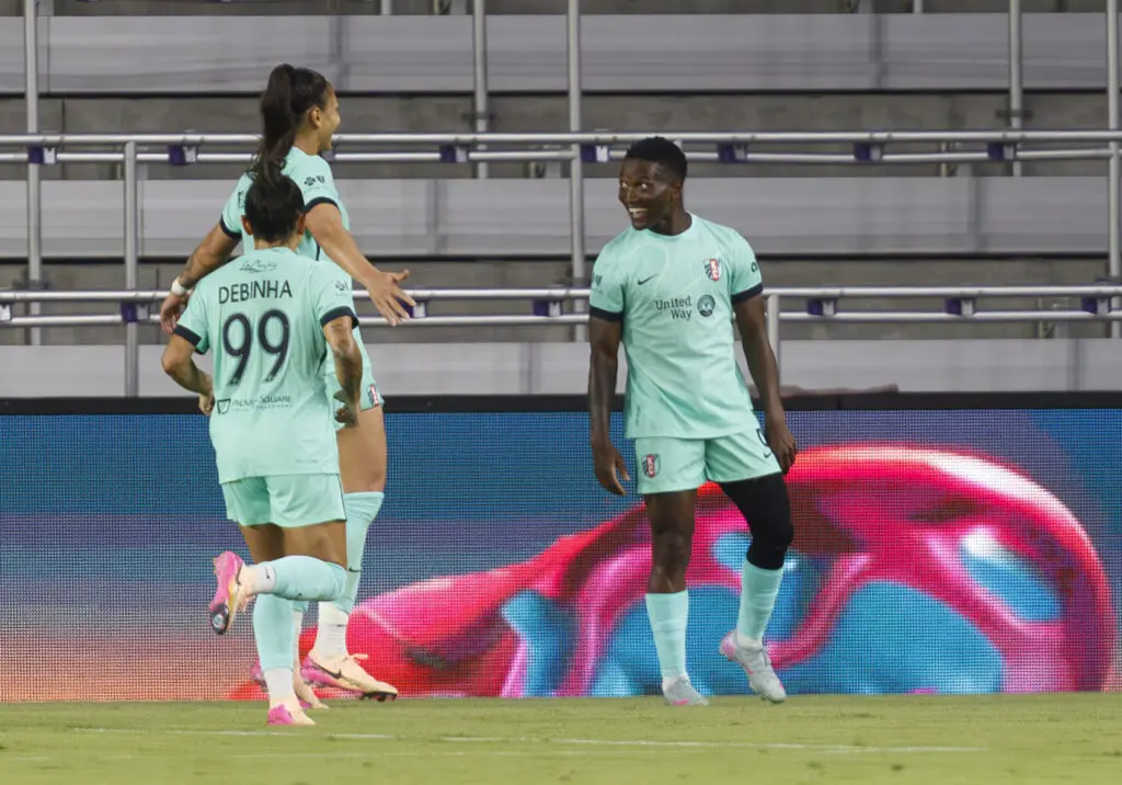 Temwa Chawinga celebrates her game-winning goal against Orlando with Kansas City teammates Bia Zaneratto and Debinha.