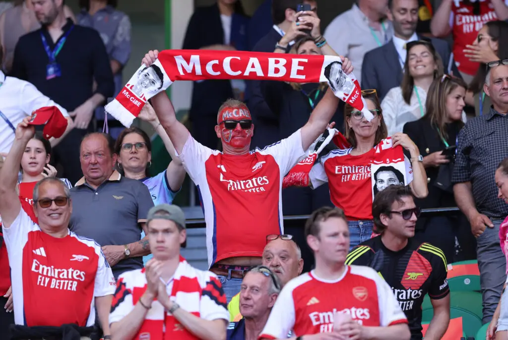 An Arsenal fan holds up a scarf for Katie McCabe during the 2024/25 UEFA Champions League final.