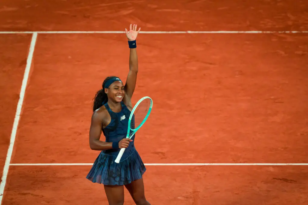 US tennis star Coco Gauff waves to the 2025 French Open crowd after securing her semifinal victory.