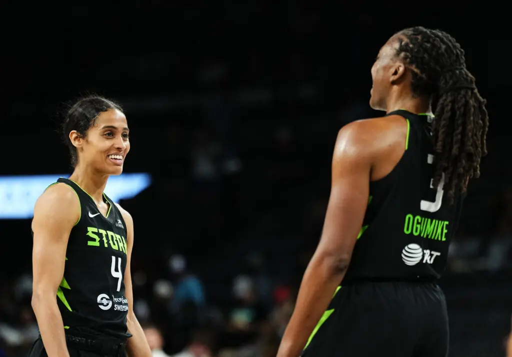 Seattle Storm players Skylar Diggins and Nneka Ogwumike laugh during a 2025 WNBA game.