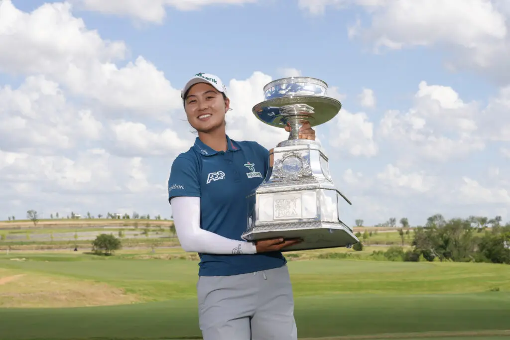Minjee Lee holds the 2025 KPMG Women's PGA Championship trophy after her win.