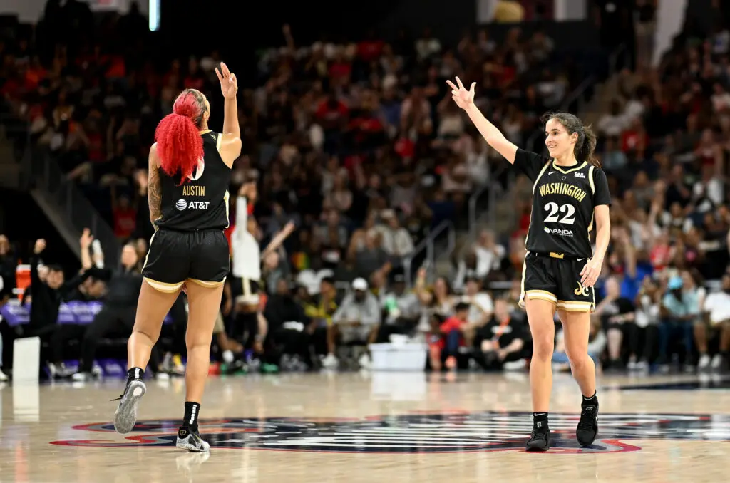 Washington's Sonia Citron and Shakira Austin celebrate a three-pointer during a 2025 WNBA game.