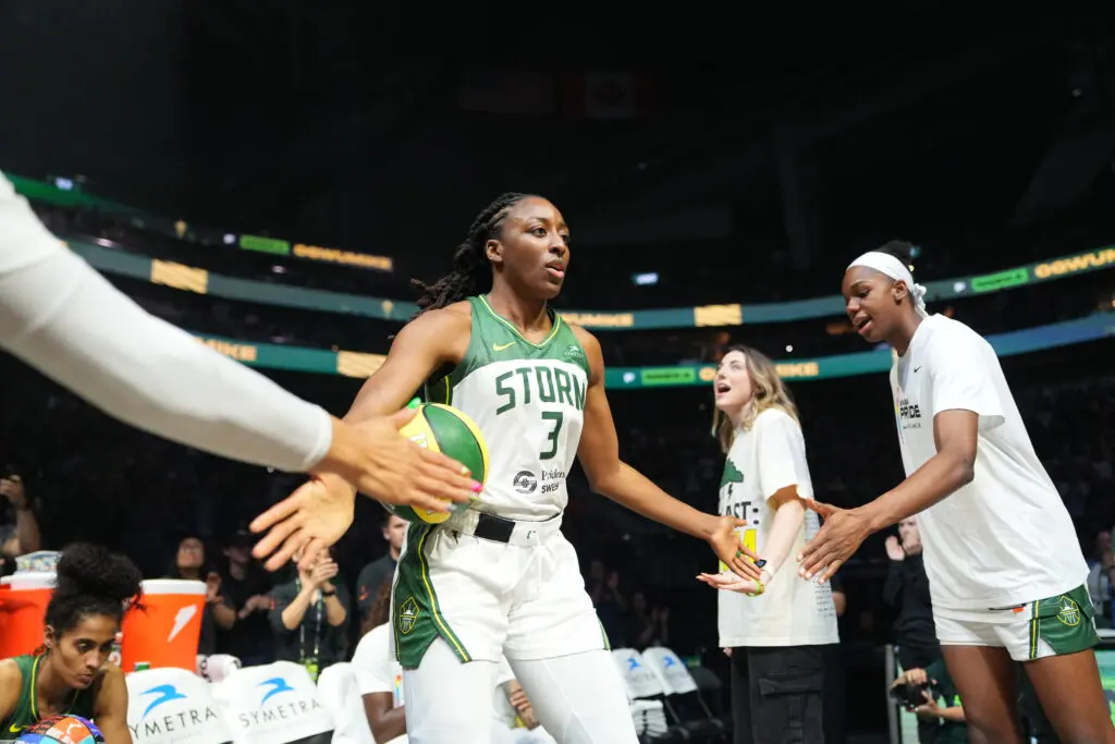 Seattle Storm star Nneka Ogwumike high-fives teammates as she's introduced before a 2025 WNBA game.