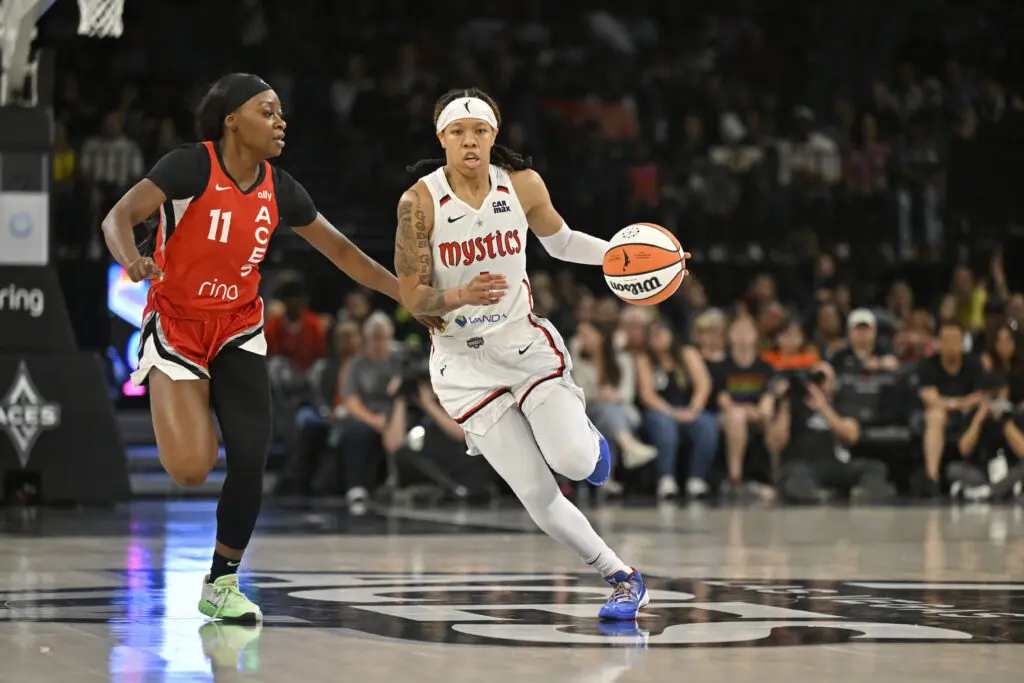 Las Vegas guard Dana Evans defends as Washington Mystics guard Sug Sutton drives to the basket during a 2025 WNBA game.