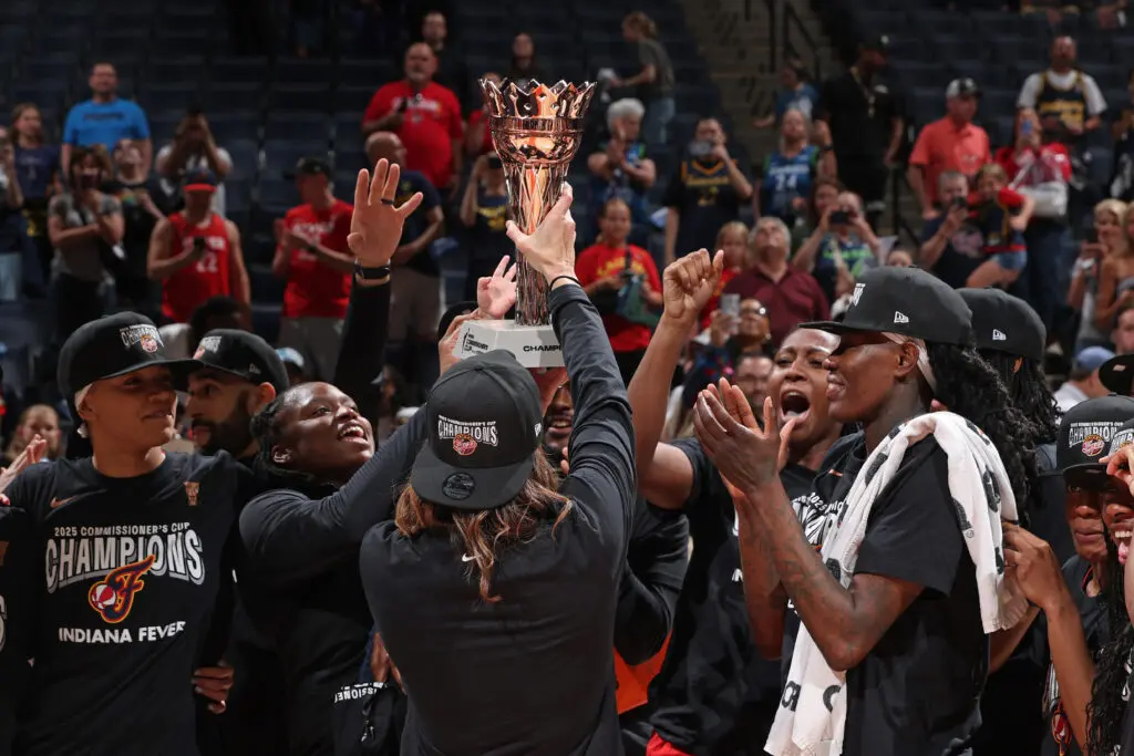 The Indiana Fever celebrate and lift the 2025 WNBA Commissioner's Cup trophy.