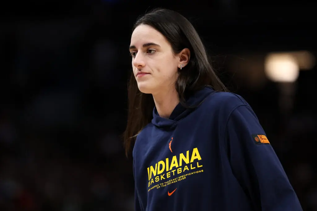 Injured Indiana Fever guard Caitlin Clark watches the 2025 WNBA Commissioner's Cup final from the bench.