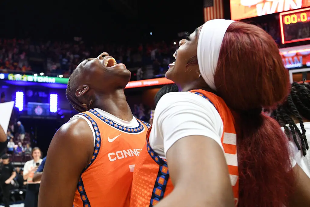 Connecticut Sun rookie guards Saniya Rivers and Aneesah Morrow bump chests in celebration of a 2025 WNBA win.
