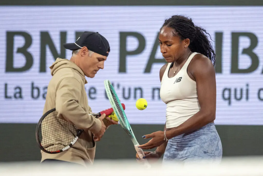 US tennis star Coco Gauff consults with coach Matt Daly during a 2025 French Open practice session.