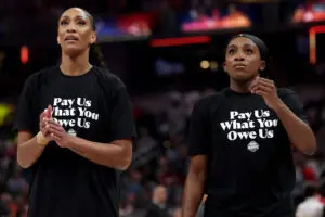 Las Vegas Aces center A'ja Wilson and guard Jackie Young wear T-shirts saying "Pay Us What You Owe Us" before the 2025 WNBA All-Star Game.