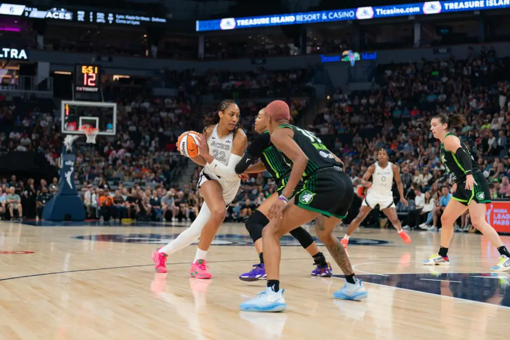 Las Vegas Aces star A'ja Wilson drives against Minnesota Lynx standout Napheesa Collier during a 2025 WNBA game.