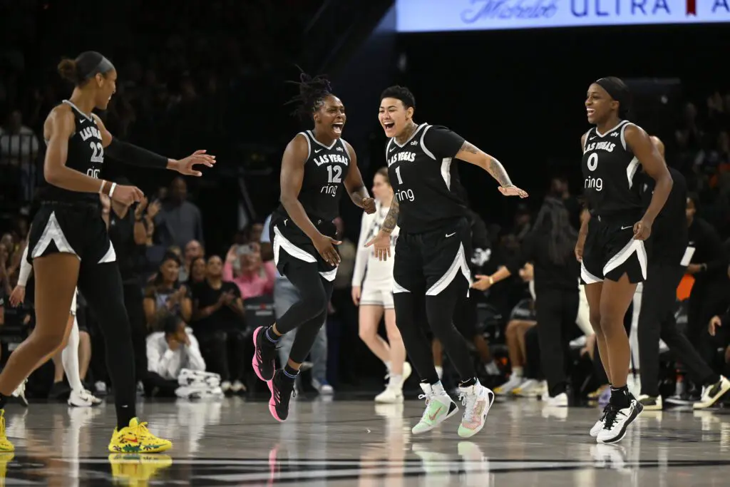 Las Vegas stars A'ja Wilson, Chelsea Gray, Kierstan Bell, and Jackie Young celebrate during a 2025 WNBA game.
