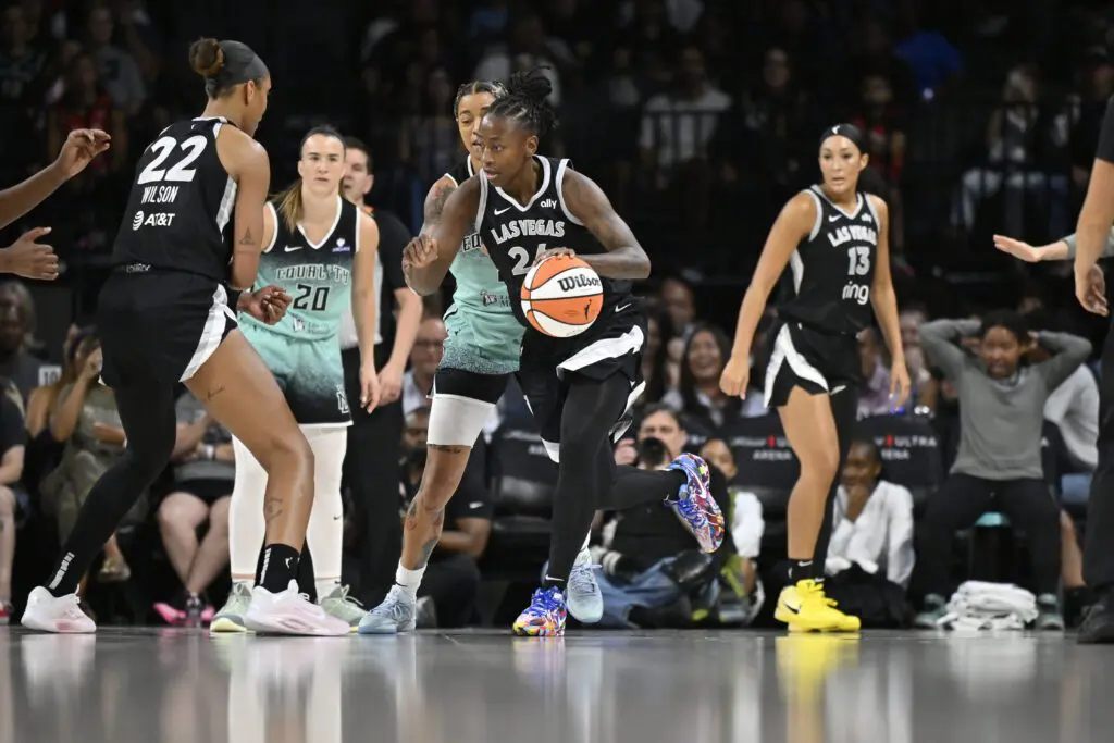 Las Vegas Aces guard Jewell Loyd dribbles the ball during a 2025 WNBA game against the New York Liberty.