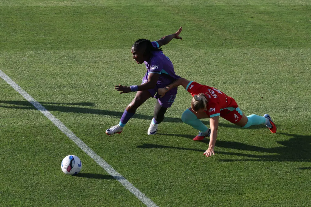 Kansas City Current defender Hailie Mace challenges Orlando Pride striker Barbra Banda during a 2025 NWSL match.