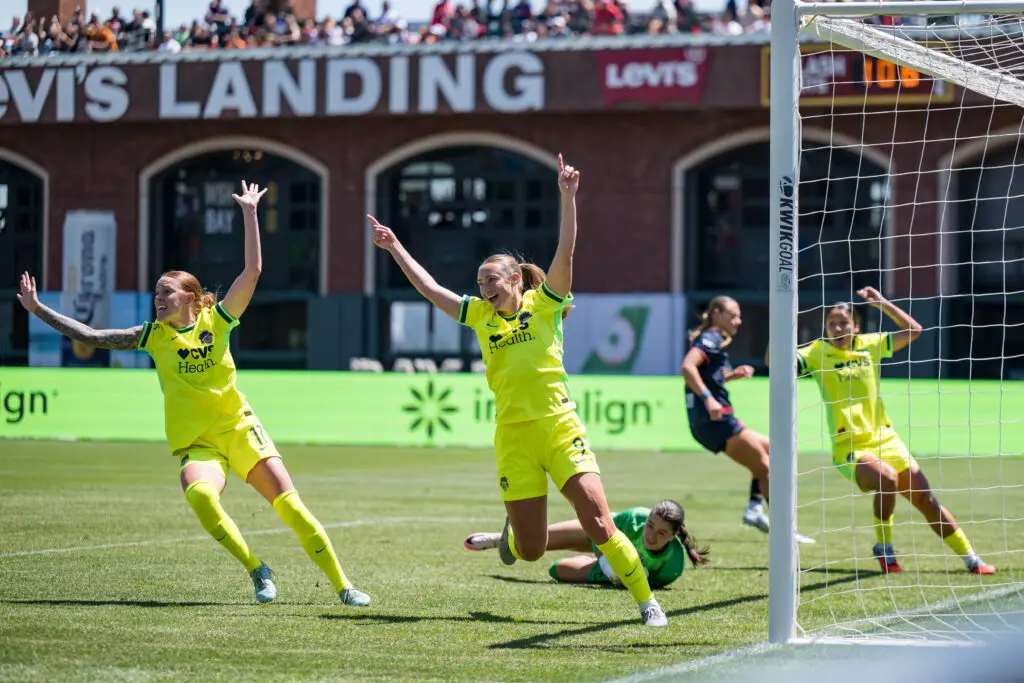 Washington Spirit defenders Hal Hershfelt and Tara McKeown celebrate a goal against Bay FC during a 2025 NWSL match.