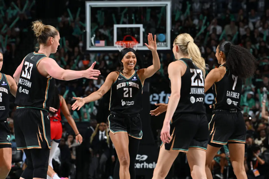 New York Liberty forward Isabelle Harrison celebrates a play with her teammates during a 2025 WNBA game.