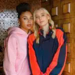 Close Friends Only Instagram podcast hosts Azzi Fudd and Paige Bueckers pose in the doorway of a house.